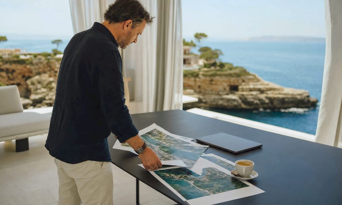 Real estate agent reviewing Mallorca coastal property documents